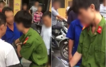 nam thanh nien mac quan phuc bi nguoi dan vay danh giua pho la cong an nghi a vu